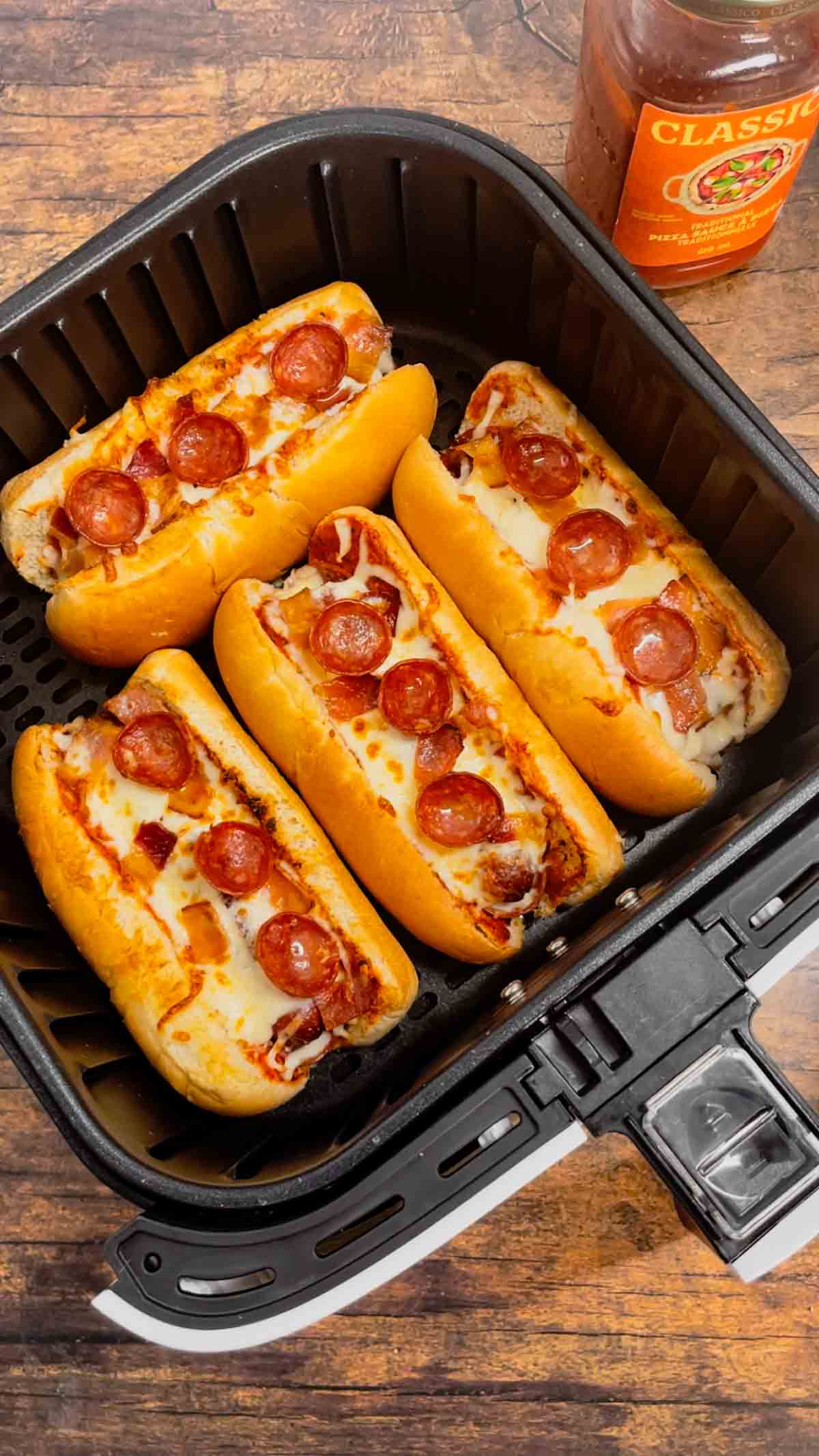 Air Fryer Pizza Dogs are a fun and easy recipe perfect for lunch or a quick weeknight dinner. These tasty hot dogs are loaded with pizza sauce, mozzarella cheese, pepperoni and bacon all air fried to crispy perfection.