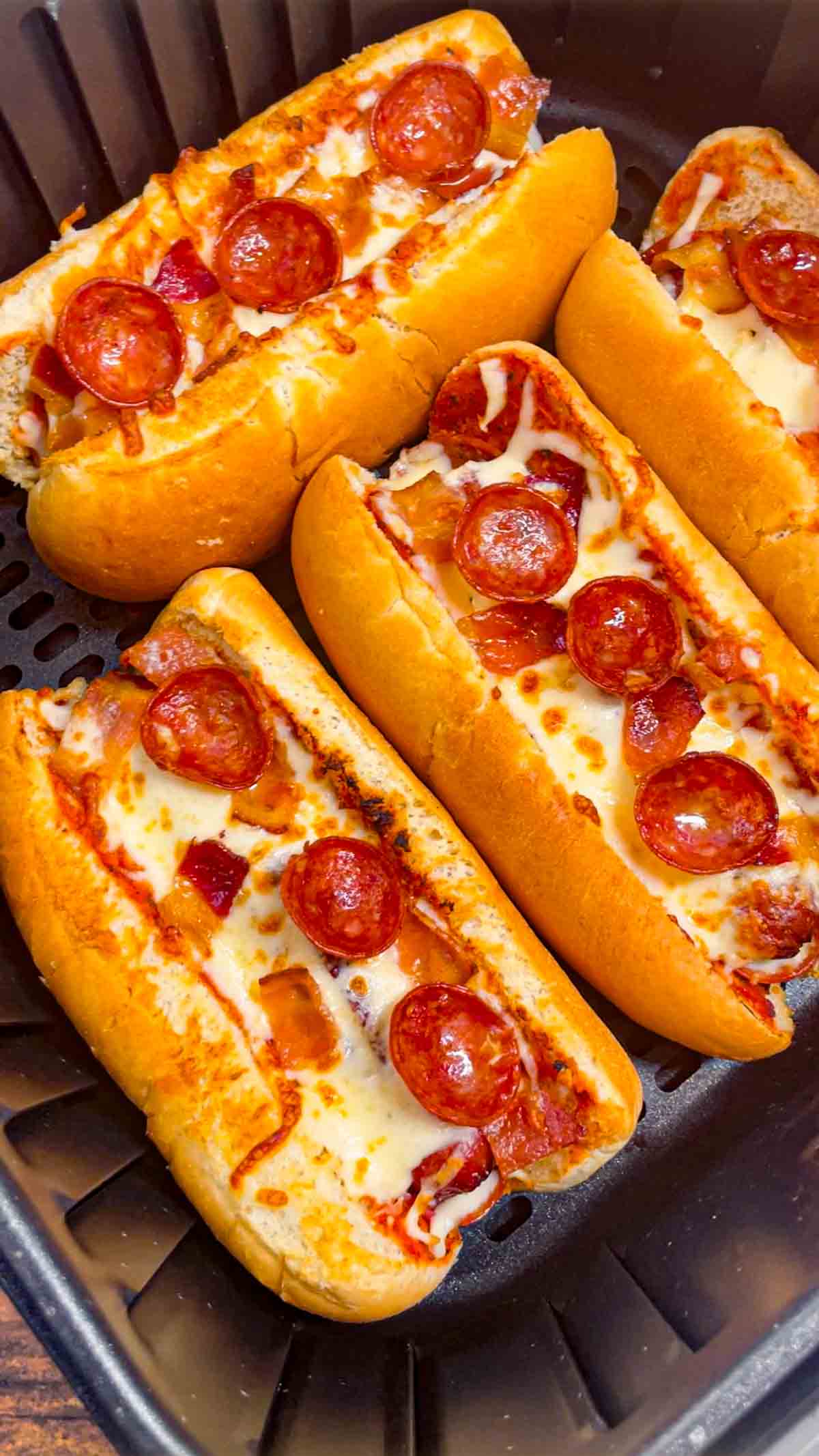 Air Fryer Pizza Dogs are a fun and easy recipe perfect for lunch or a quick weeknight dinner. These tasty hot dogs are loaded with pizza sauce, mozzarella cheese, pepperoni and bacon all air fried to crispy perfection.