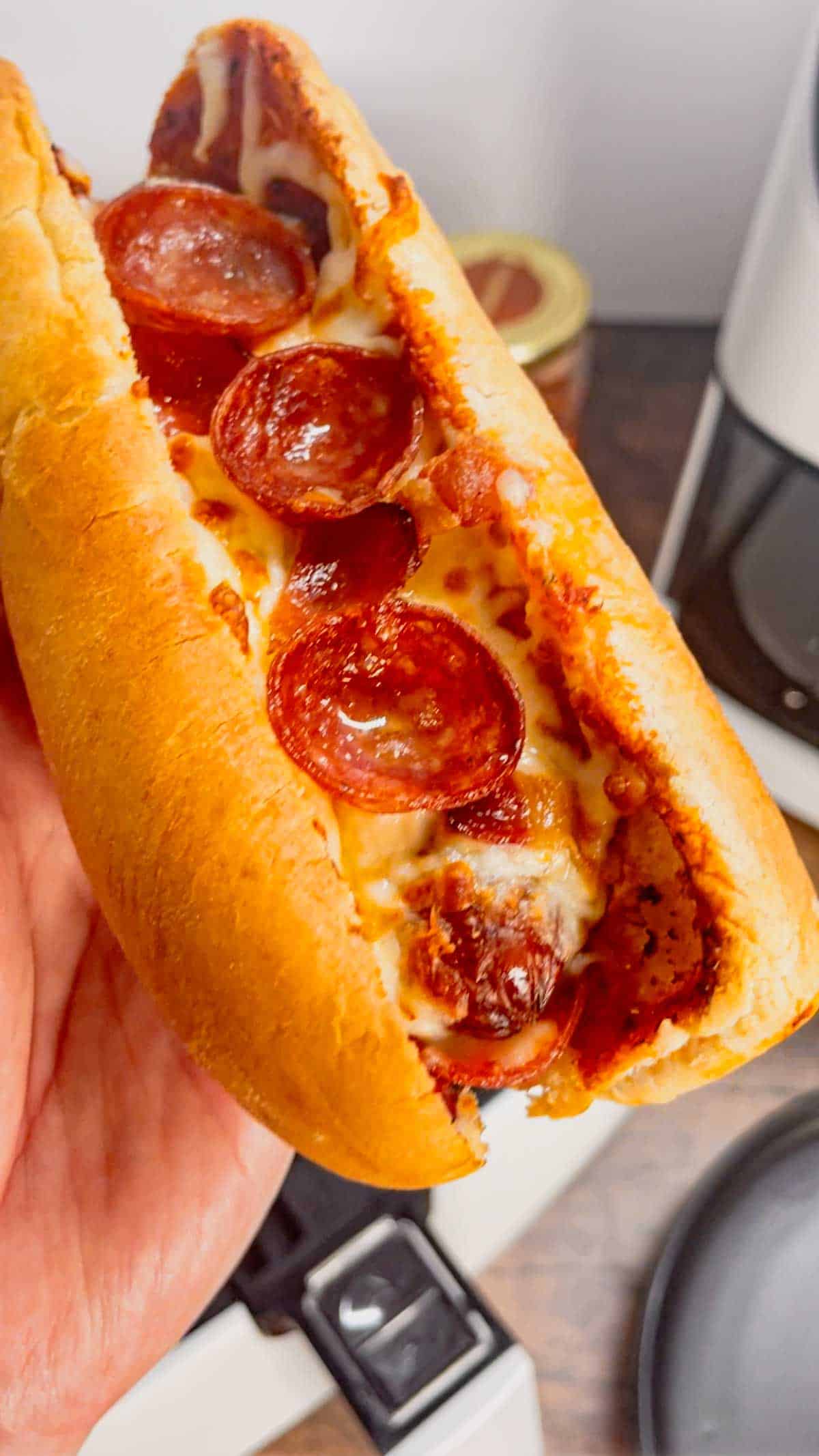 Air Fryer Pizza Dogs are a fun and easy recipe perfect for lunch or a quick weeknight dinner. These tasty hot dogs are loaded with pizza sauce, mozzarella cheese, pepperoni and bacon all air fried to crispy perfection.
