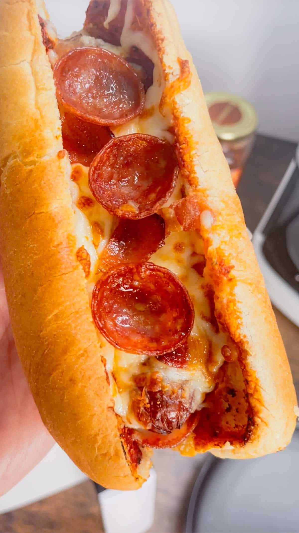 Air Fryer Pizza Dogs are a fun and easy recipe perfect for lunch or a quick weeknight dinner. These tasty hot dogs are loaded with pizza sauce, mozzarella cheese, pepperoni and bacon all air fried to crispy perfection.