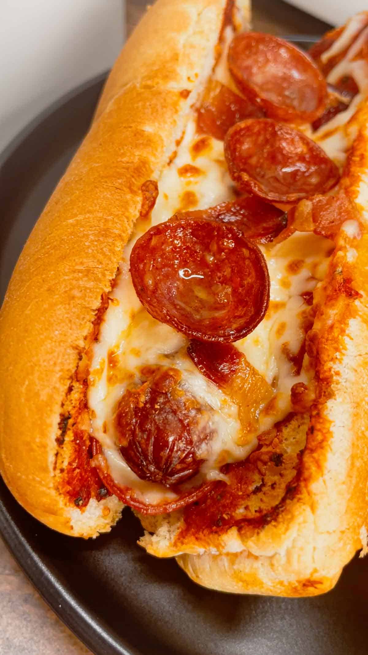 Air Fryer Pizza Dogs are a fun and easy recipe perfect for lunch or a quick weeknight dinner. These tasty hot dogs are loaded with pizza sauce, mozzarella cheese, pepperoni and bacon all air fried to crispy perfection.