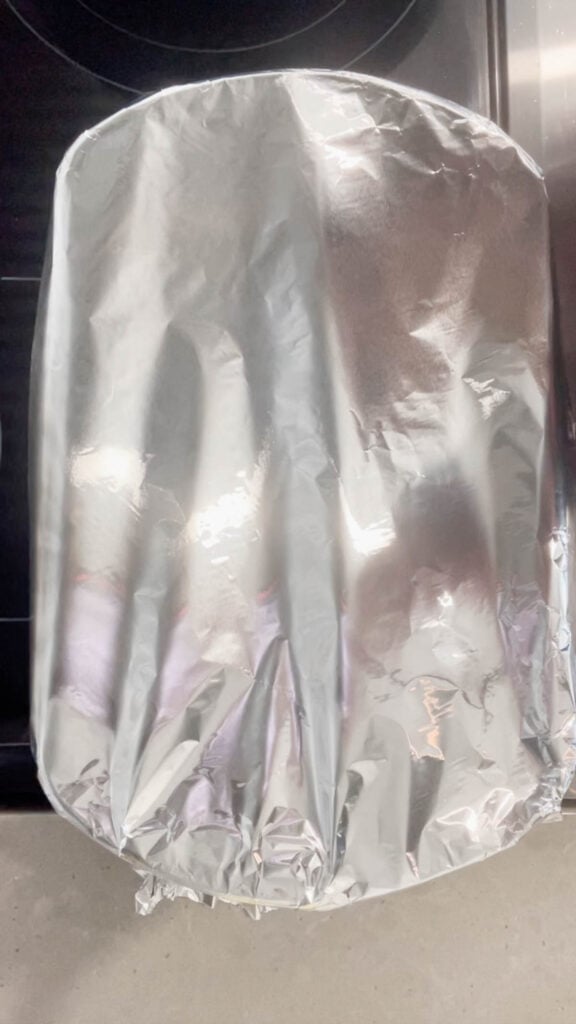 foil covered baking dish on the stove top