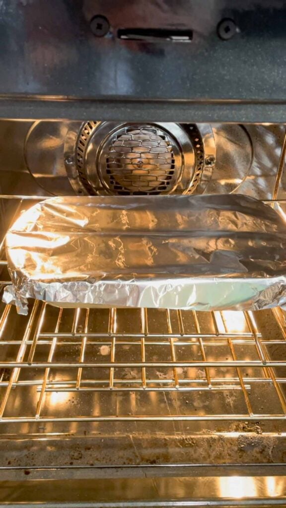 foil covered baking dish in the oven