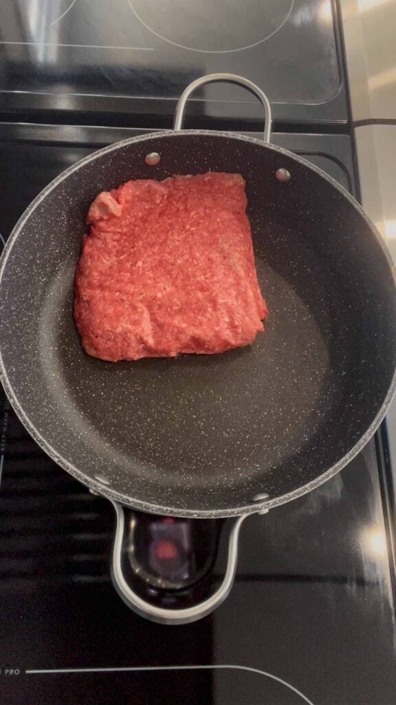 raw ground beef in a skillet
