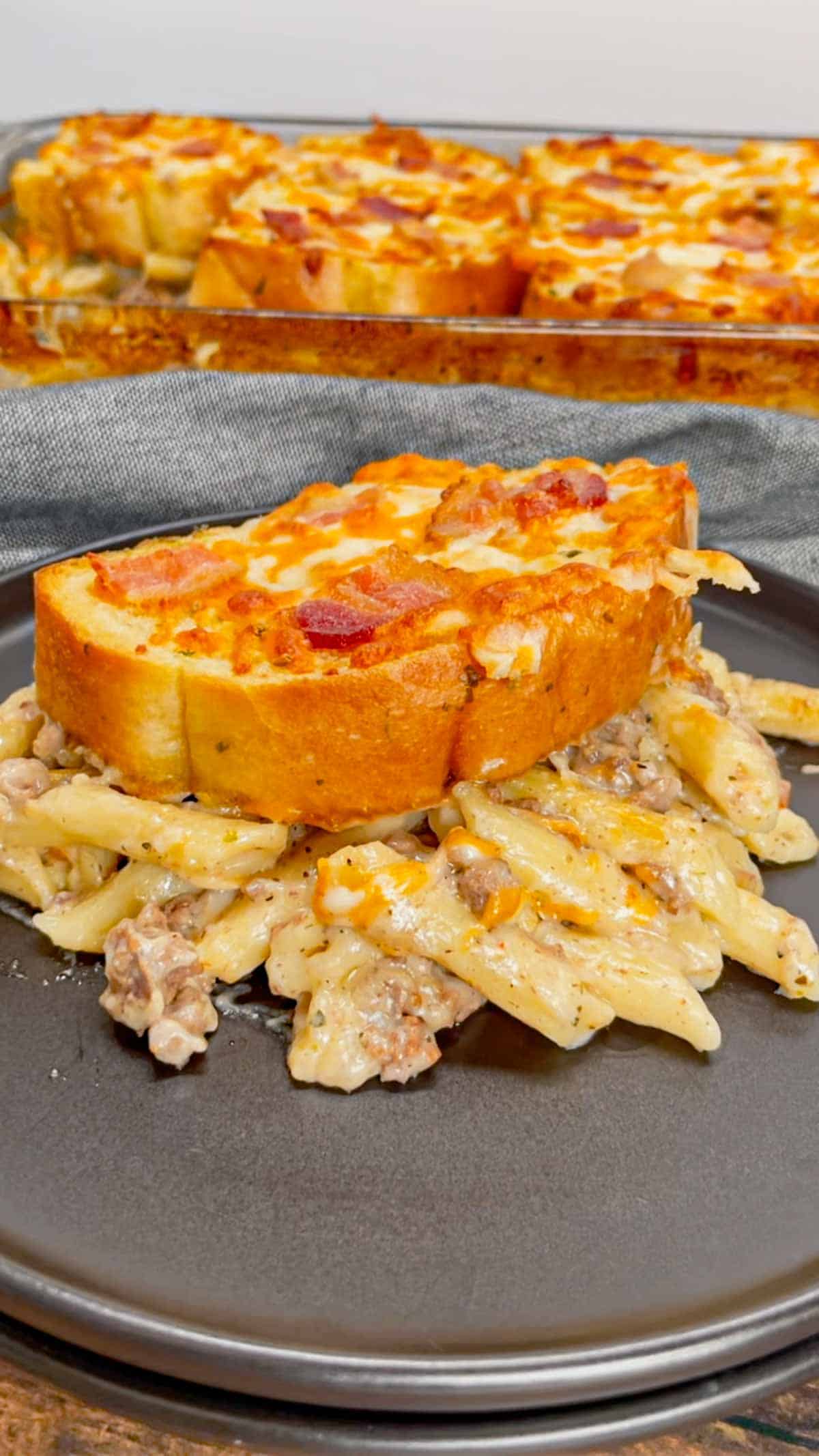 Dump and Bake Ground Beef Alfredo is an easy one pan dinner recipe perfect for weeknights. This creamy pasta recipe is made with store bought alfredo sauce, chicken broth, mini penne noodles, cream of bacon soup, ground beef, mozzarella and cheddar cheese, Texas toast garlic bread and bacon.