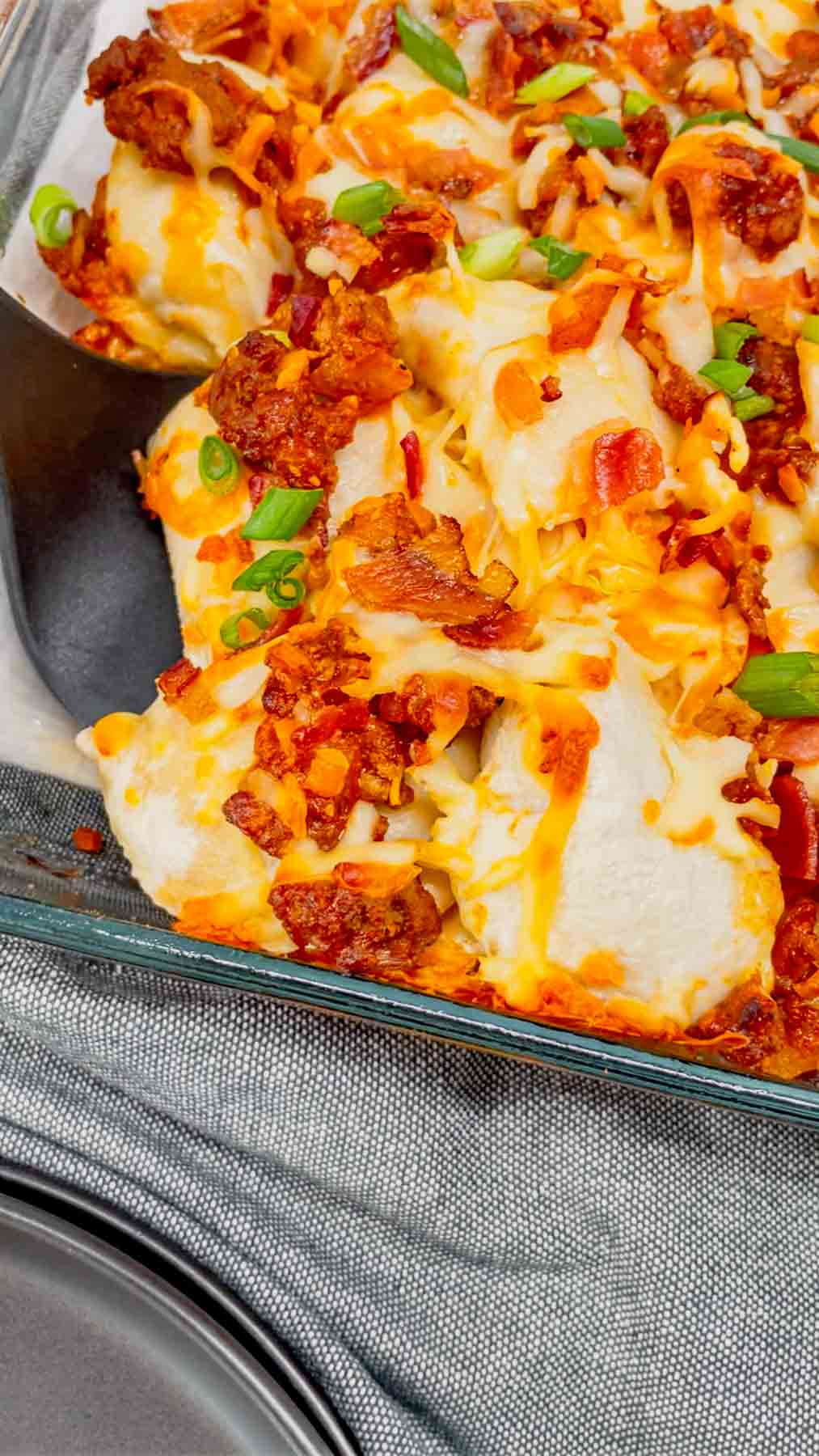 Sloppy Joe Pierogi Casserole is a hearty casserole that is super easy to throw together. This easy casserole recipe uses store bought frozen pierogies, ground beef, a homemade sloppy joe sauce, shredded mozzarella and cheddar cheese, bacon and green onions.