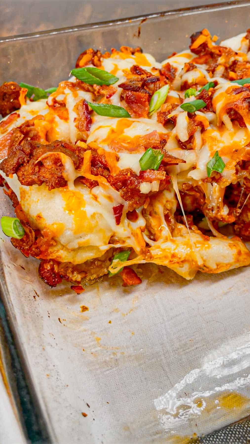 Sloppy Joe Pierogi Casserole is a hearty casserole that is super easy to throw together. This easy casserole recipe uses store bought frozen pierogies, ground beef, a homemade sloppy joe sauce, shredded mozzarella and cheddar cheese, bacon and green onions.