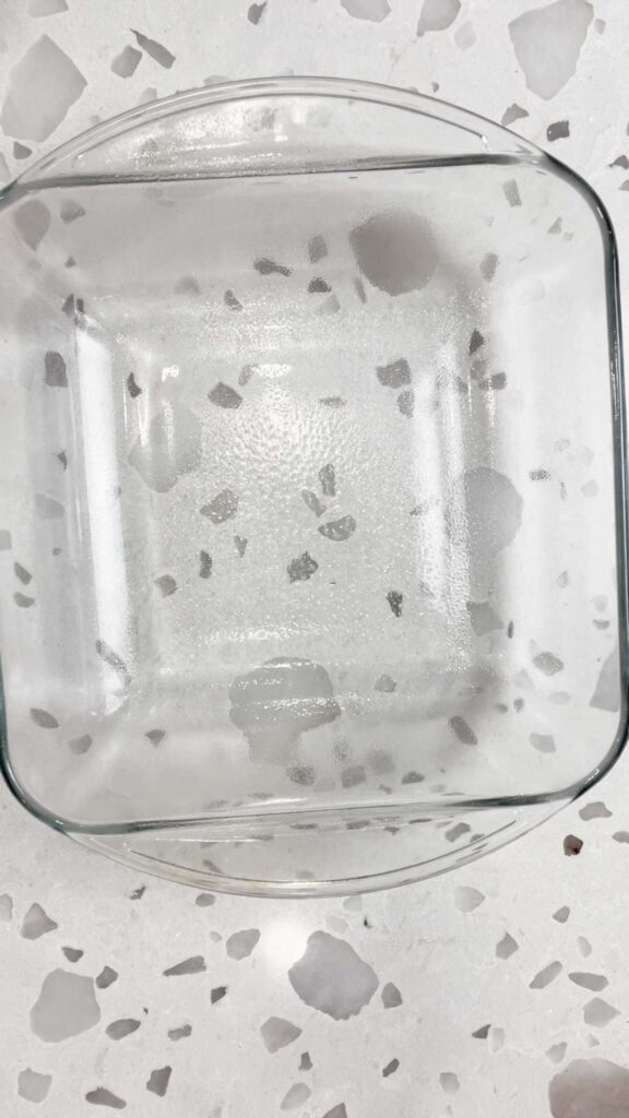 square glass baking dish sprayed with cooking spray