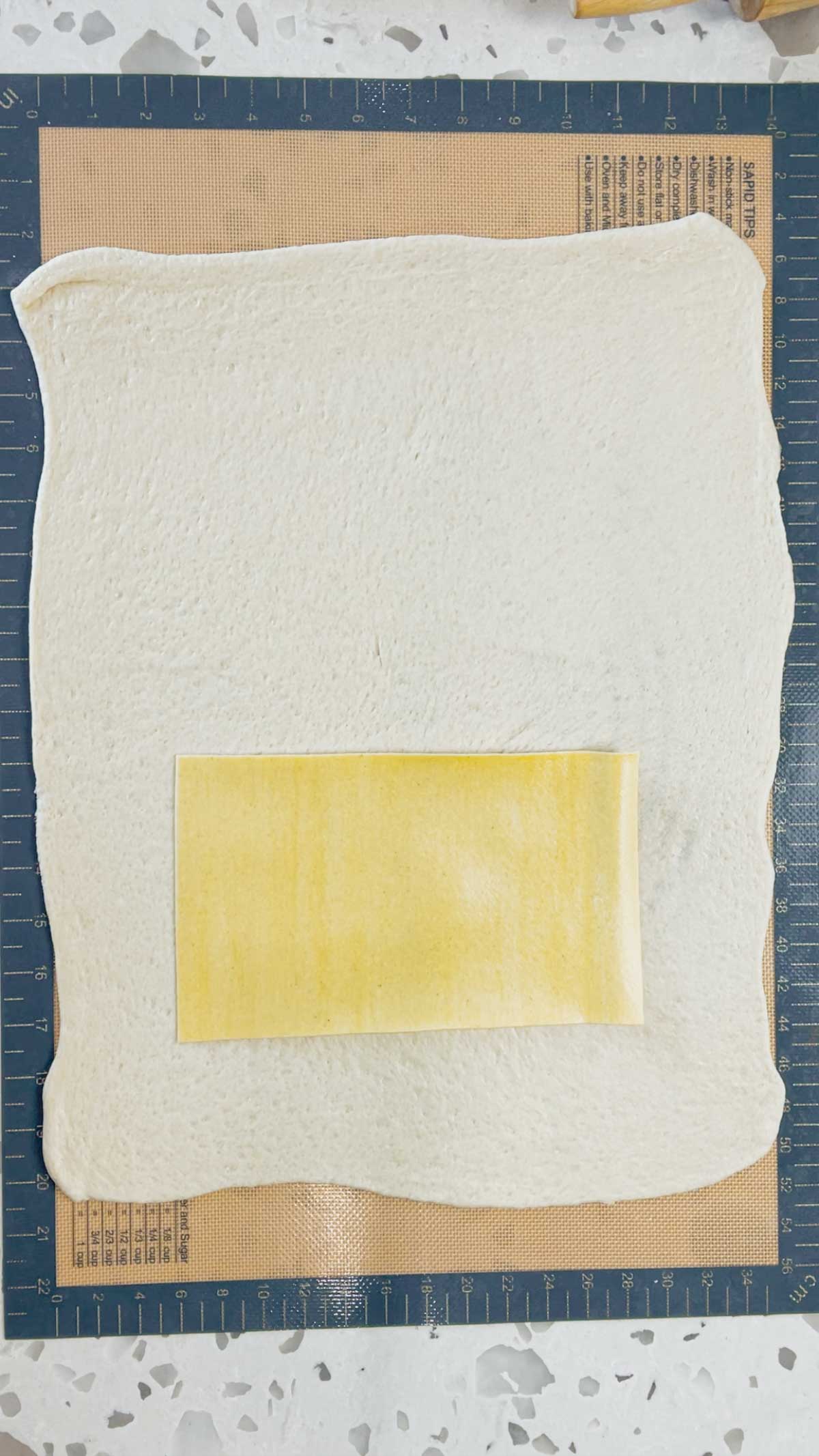 lasagna sheet placed on top of pizza dough