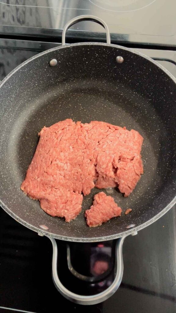 raw ground beef in a skillet