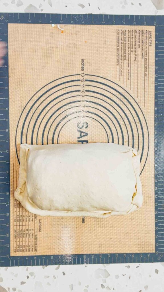 lasagna stuffed pizza dough on a silicone mat