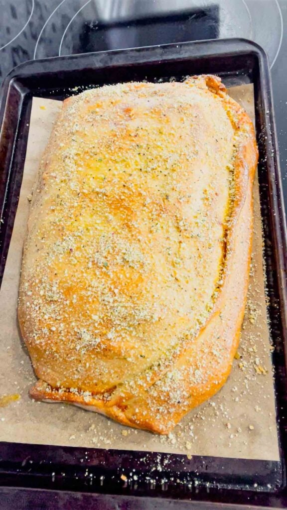 lasagna stuffed pizza dough baked until golden brown and sprinkled with grated parmesan