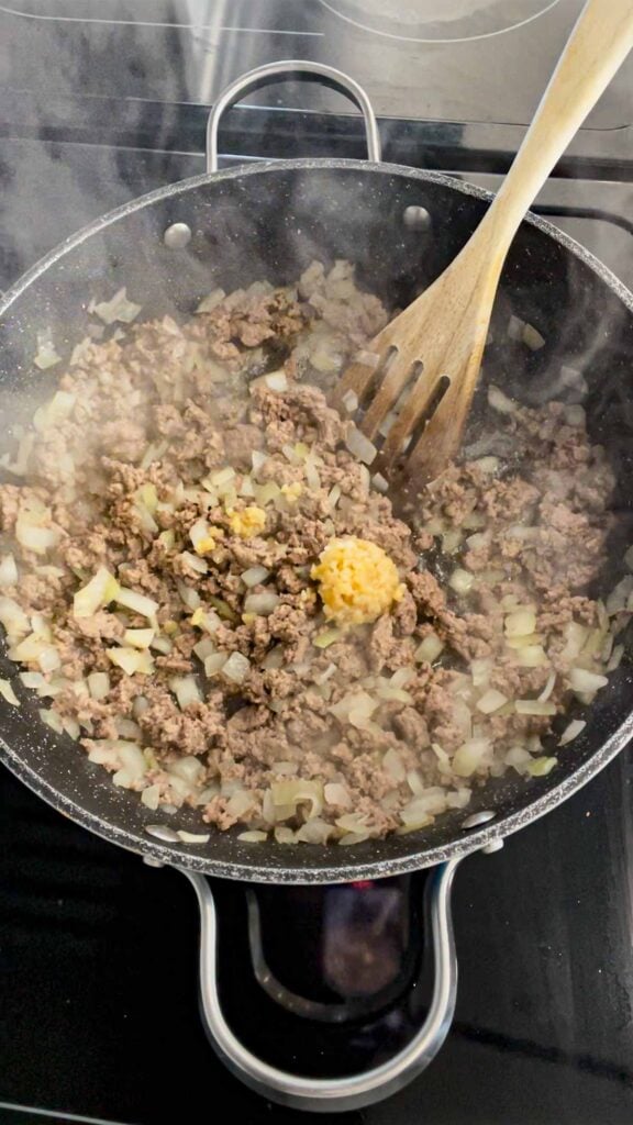 chopped garlic added to skillet with cooked ground beef and diced onions