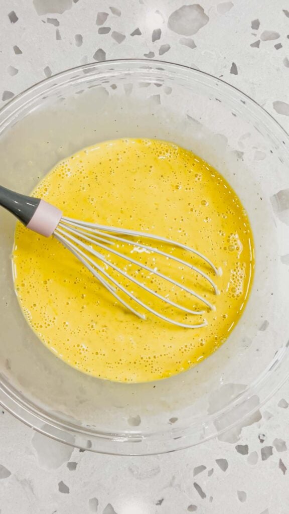 beaten egg mixture in glass mixing bowl