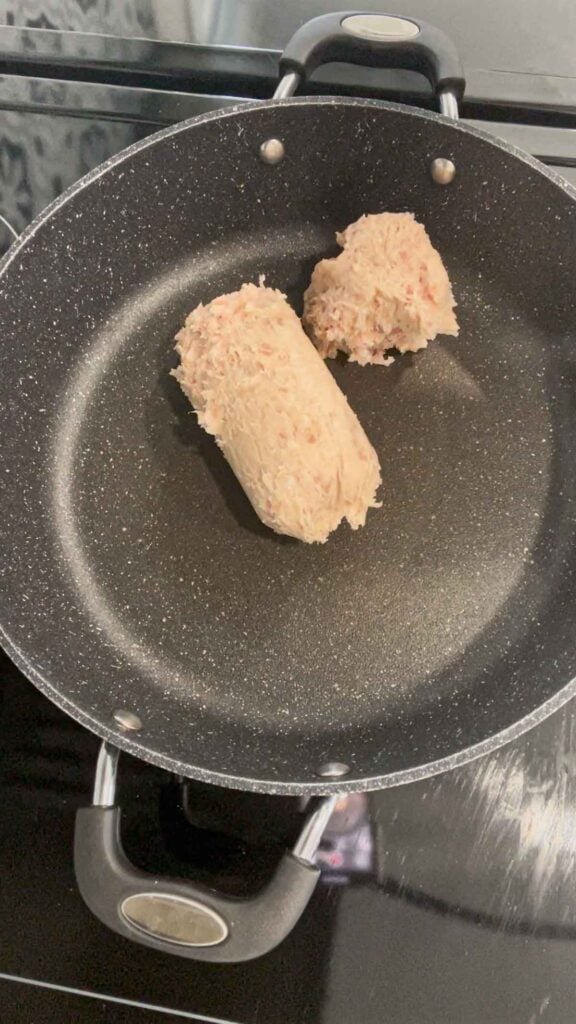 raw sausage meat in a skillet