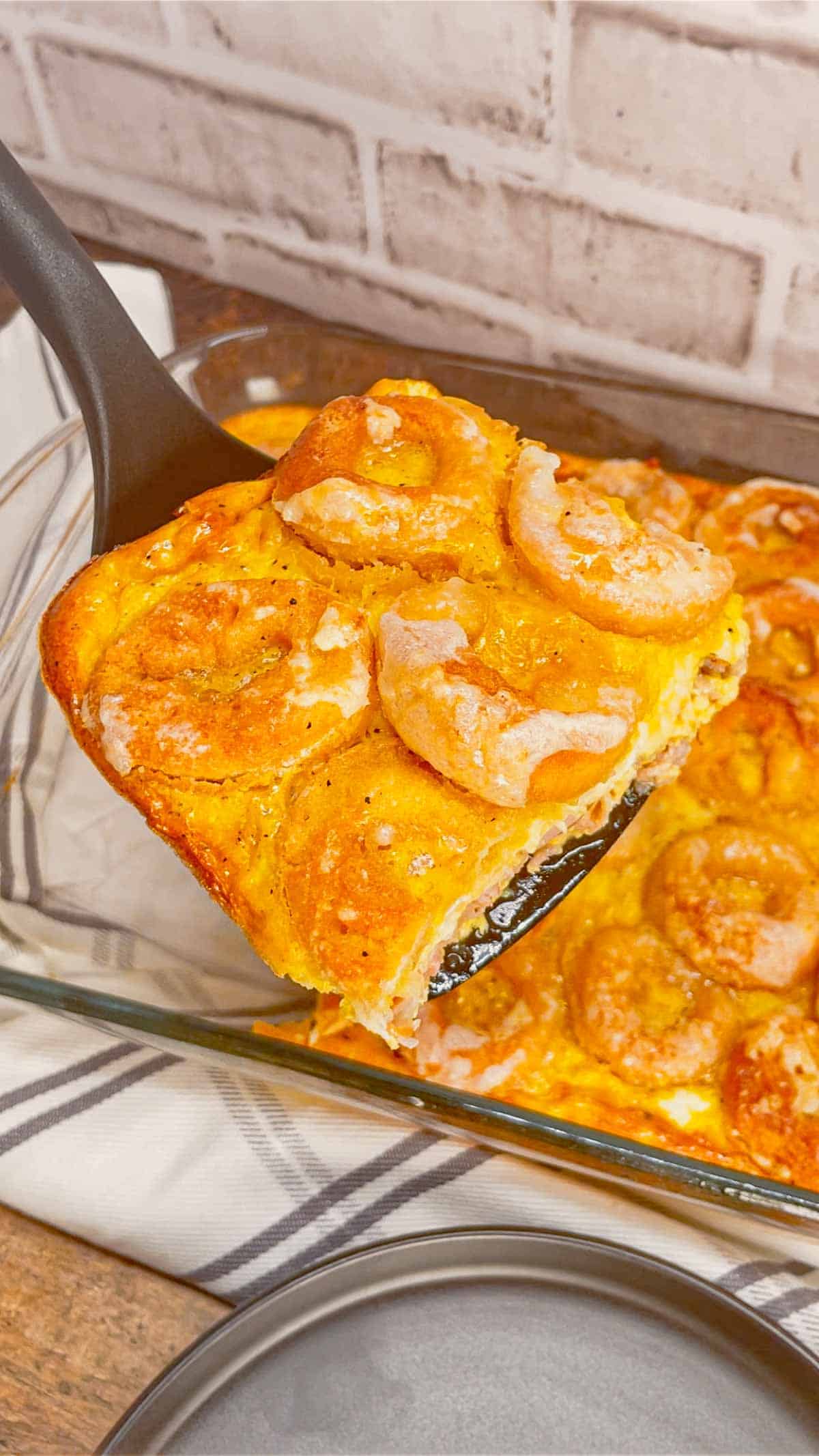 Mini Donut Breakfast Casserole is a fun and delicious brunch dish perfect for holidays and special occasions. This dish is loaded with sausage, ham, eggs, mozzarella cheese, store bought mini donuts and maple syrup.