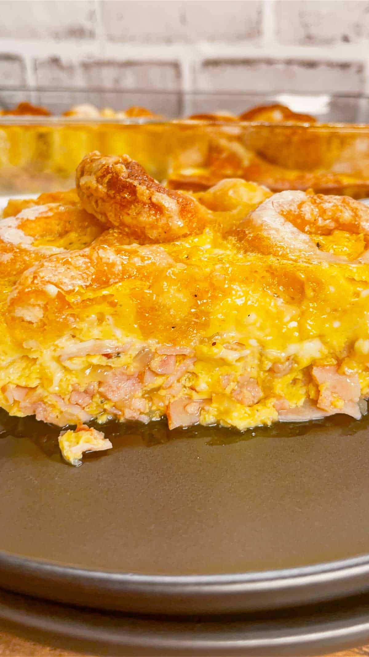 Mini Donut Breakfast Casserole is a fun and delicious brunch dish perfect for holidays and special occasions. This dish is loaded with sausage, ham, eggs, mozzarella cheese, store bought mini donuts and maple syrup.
