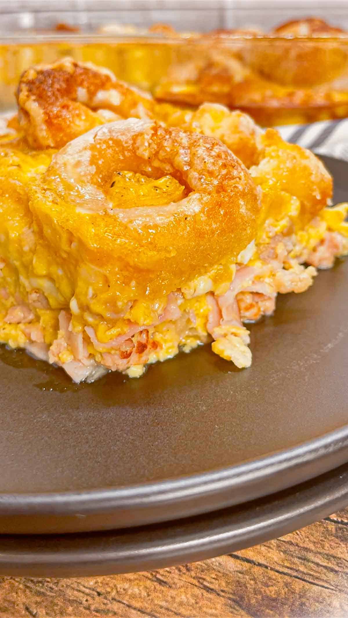 Mini Donut Breakfast Casserole is a fun and delicious brunch dish perfect for holidays and special occasions. This dish is loaded with sausage, ham, eggs, mozzarella cheese, store bought mini donuts and maple syrup.