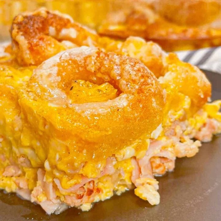 Mini Donut Breakfast Casserole is a fun and delicious brunch dish perfect for holidays and special occasions. This dish is loaded with sausage, ham, eggs, mozzarella cheese, store bought mini donuts and maple syrup.