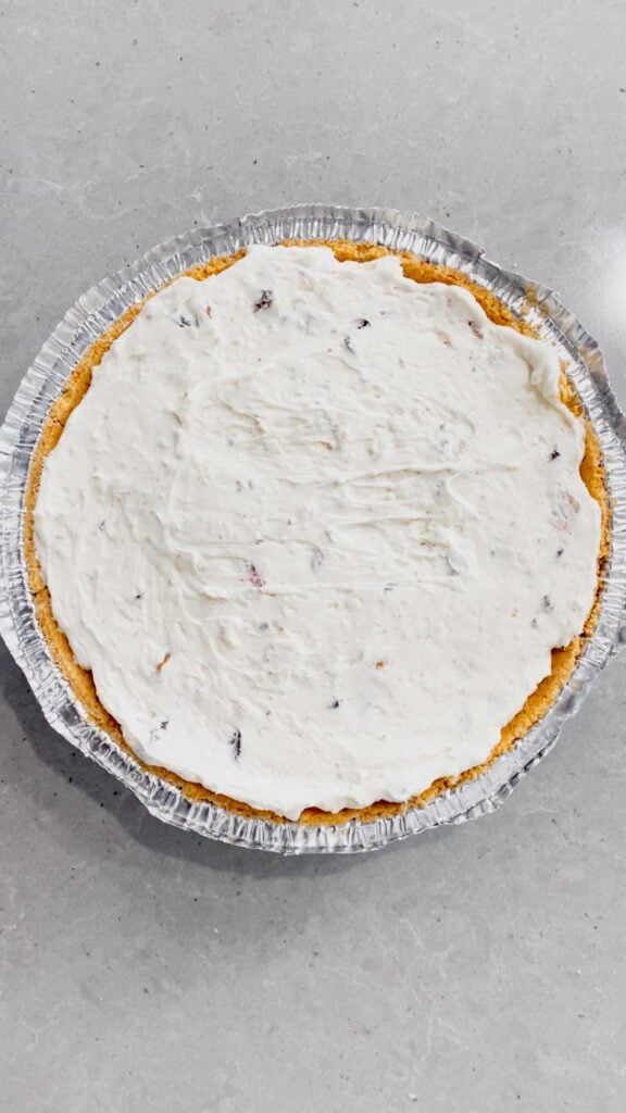 cream cheese mixture spread in a graham pie crust