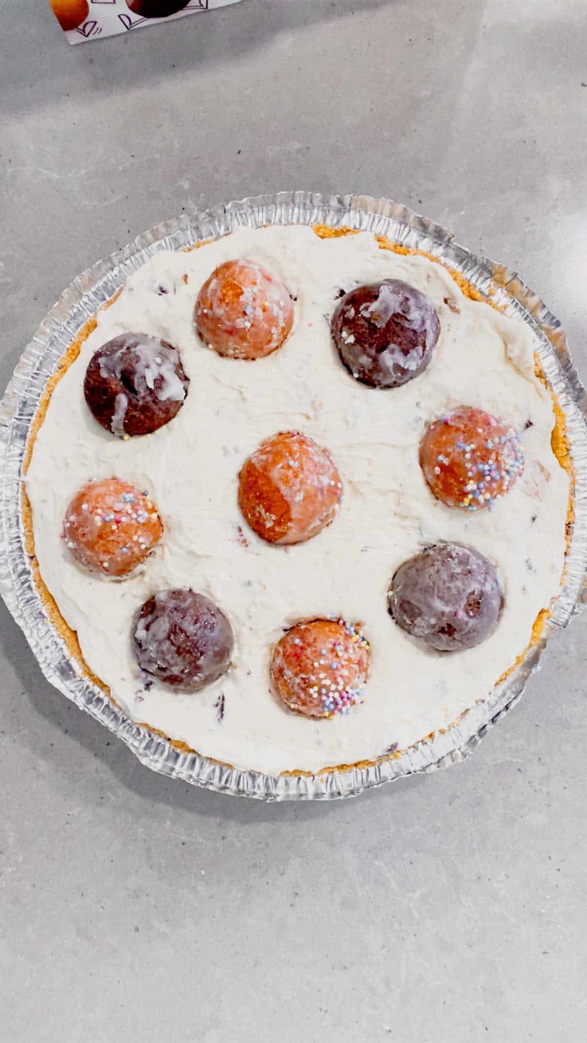 chocolate and birthday cake timbits on top of cheese cake