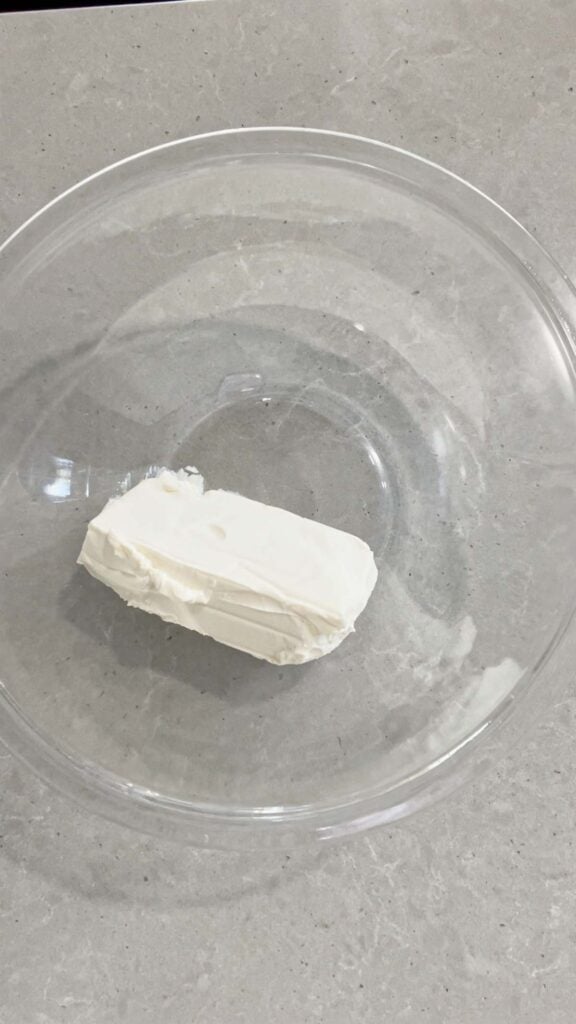 cream cheese in a glass mixing bowl