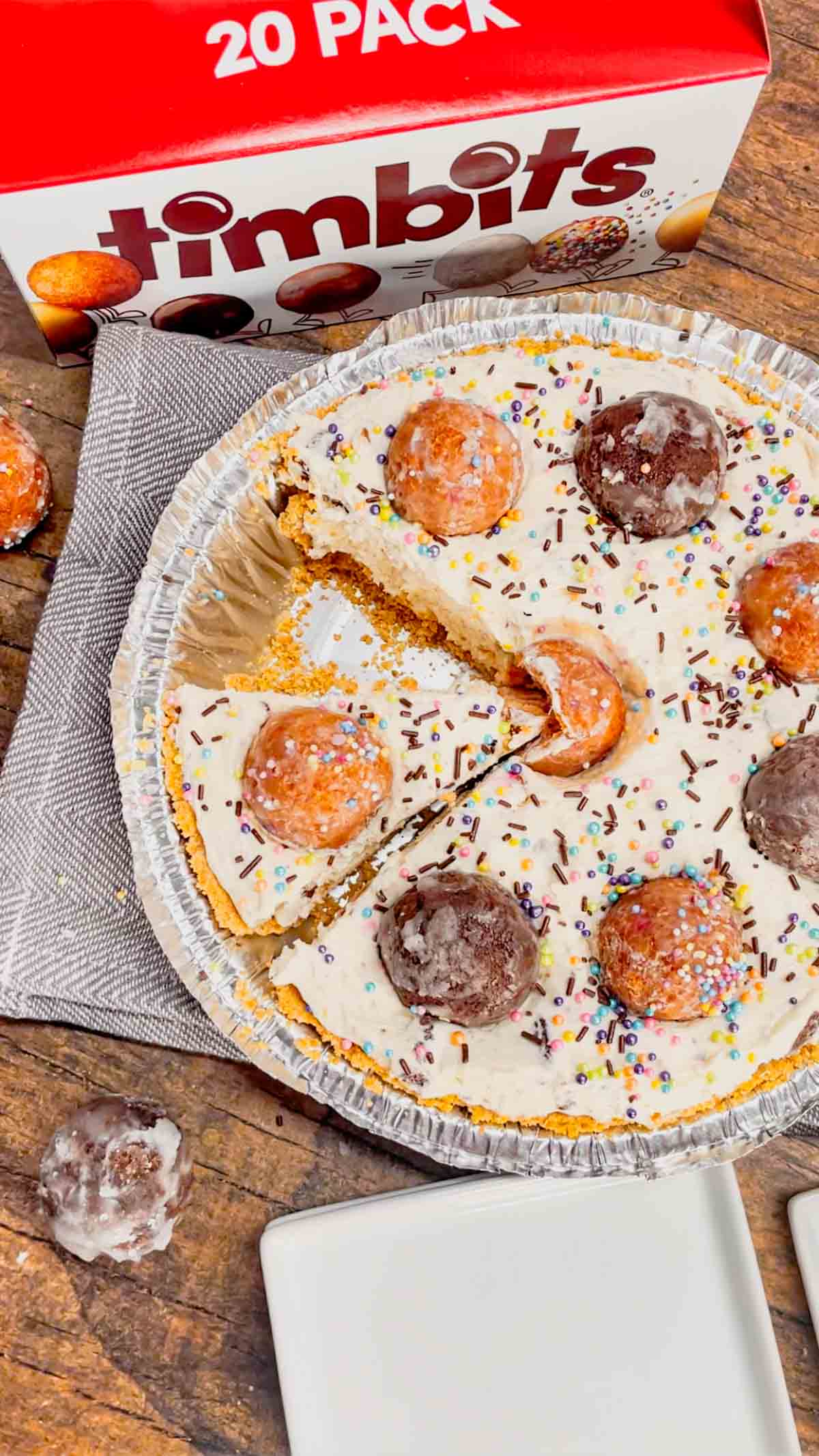 No Bake Timbit Cheesecake is a rich and creamy dessert recipe loaded with tasty donut holes. This cheesecake is made with a store bought graham pie crust and the cream cheese filling is loaded Tim Horton's chocolate and birthday cake flavoured Timbits.