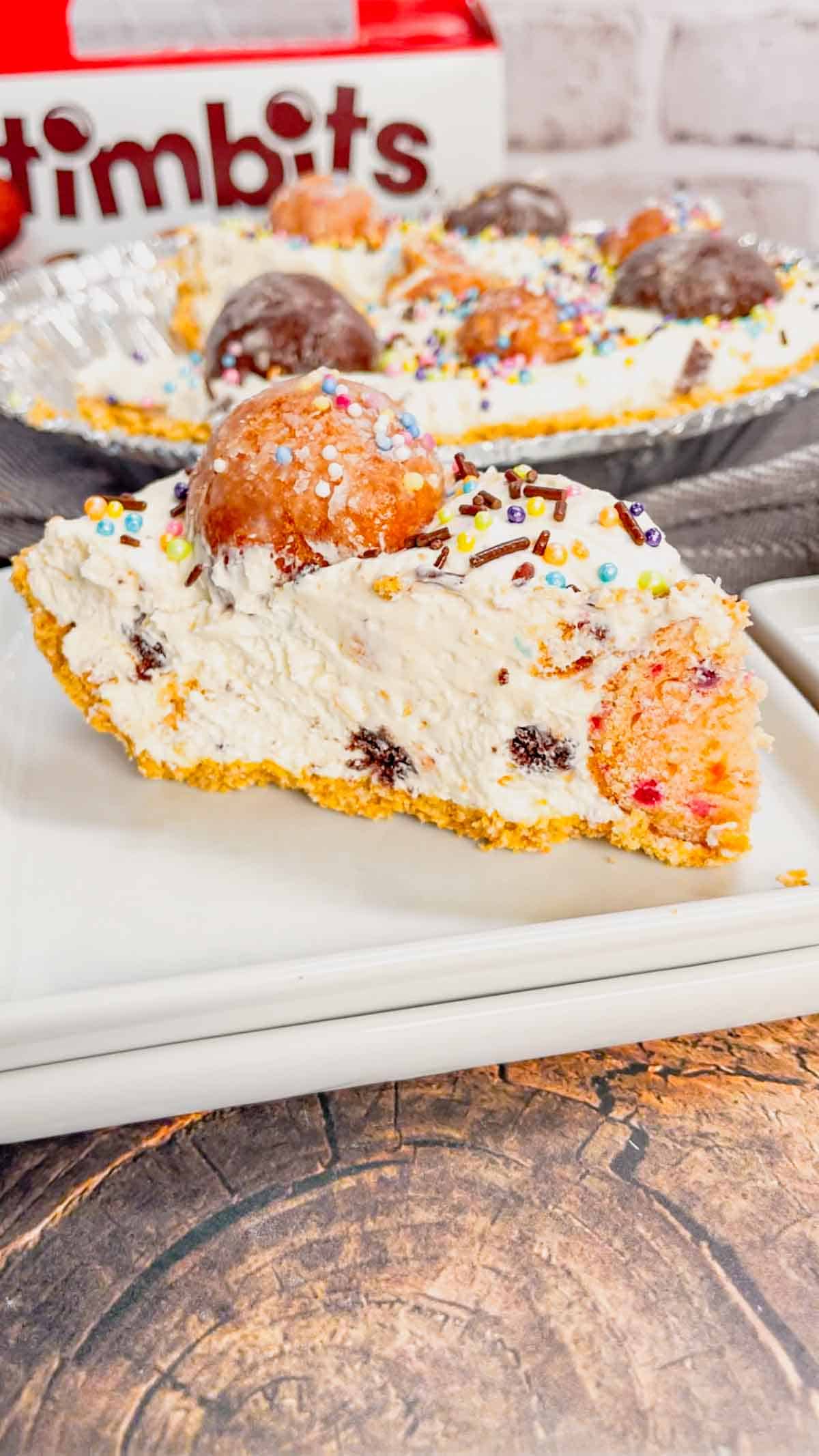 No Bake Timbit Cheesecake is a rich and creamy dessert recipe loaded with tasty donut holes. This cheesecake is made with a store bought graham pie crust and the cream cheese filling is loaded Tim Horton's chocolate and birthday cake flavoured Timbits.