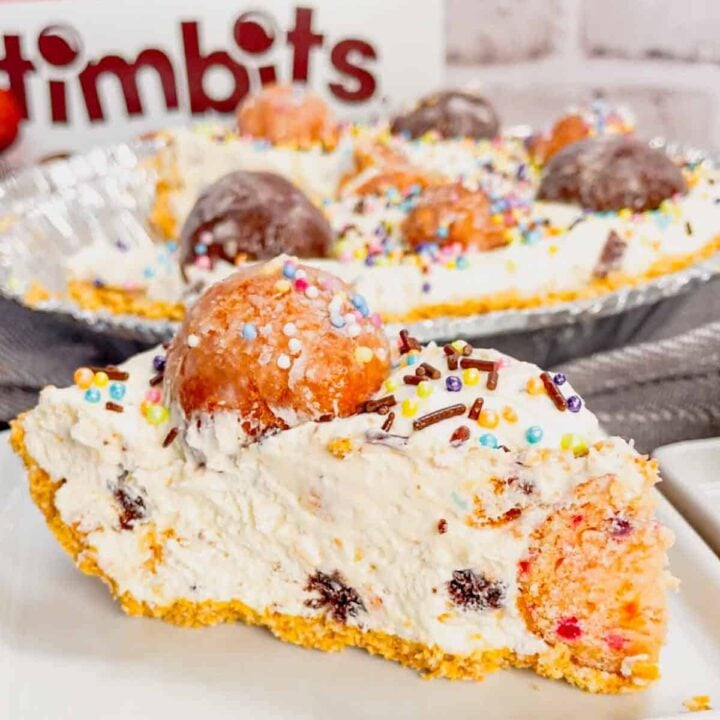 No Bake Timbit Cheesecake is a rich and creamy dessert recipe loaded with tasty donut holes. This cheesecake is made with a store bought graham pie crust and the cream cheese filling is loaded Tim Horton's chocolate and birthday cake flavoured Timbits.
