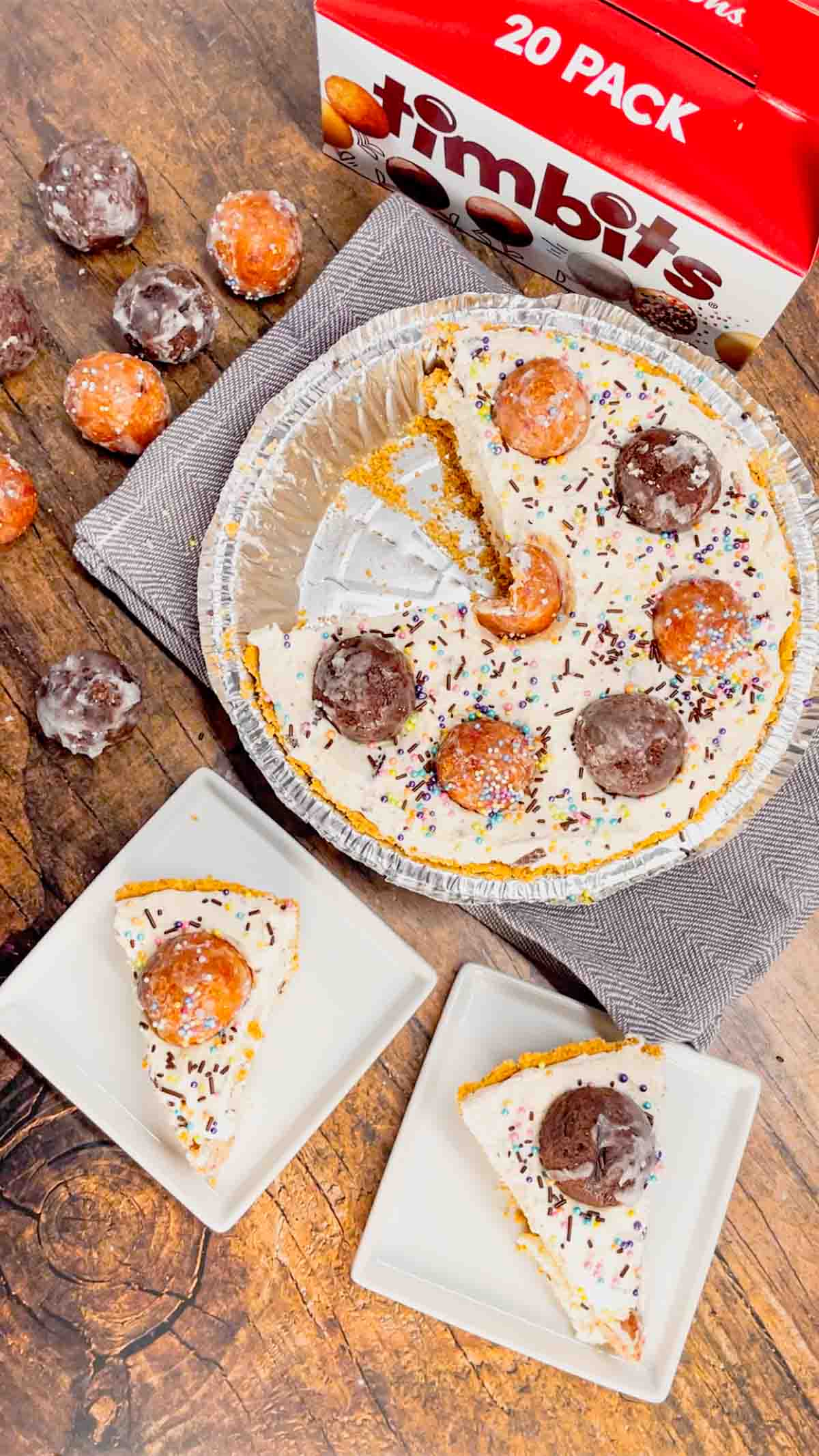 No Bake Timbit Cheesecake is a rich and creamy dessert recipe loaded with tasty donut holes. This cheesecake is made with a store bought graham pie crust and the cream cheese filling is loaded Tim Horton's chocolate and birthday cake flavoured Timbits.