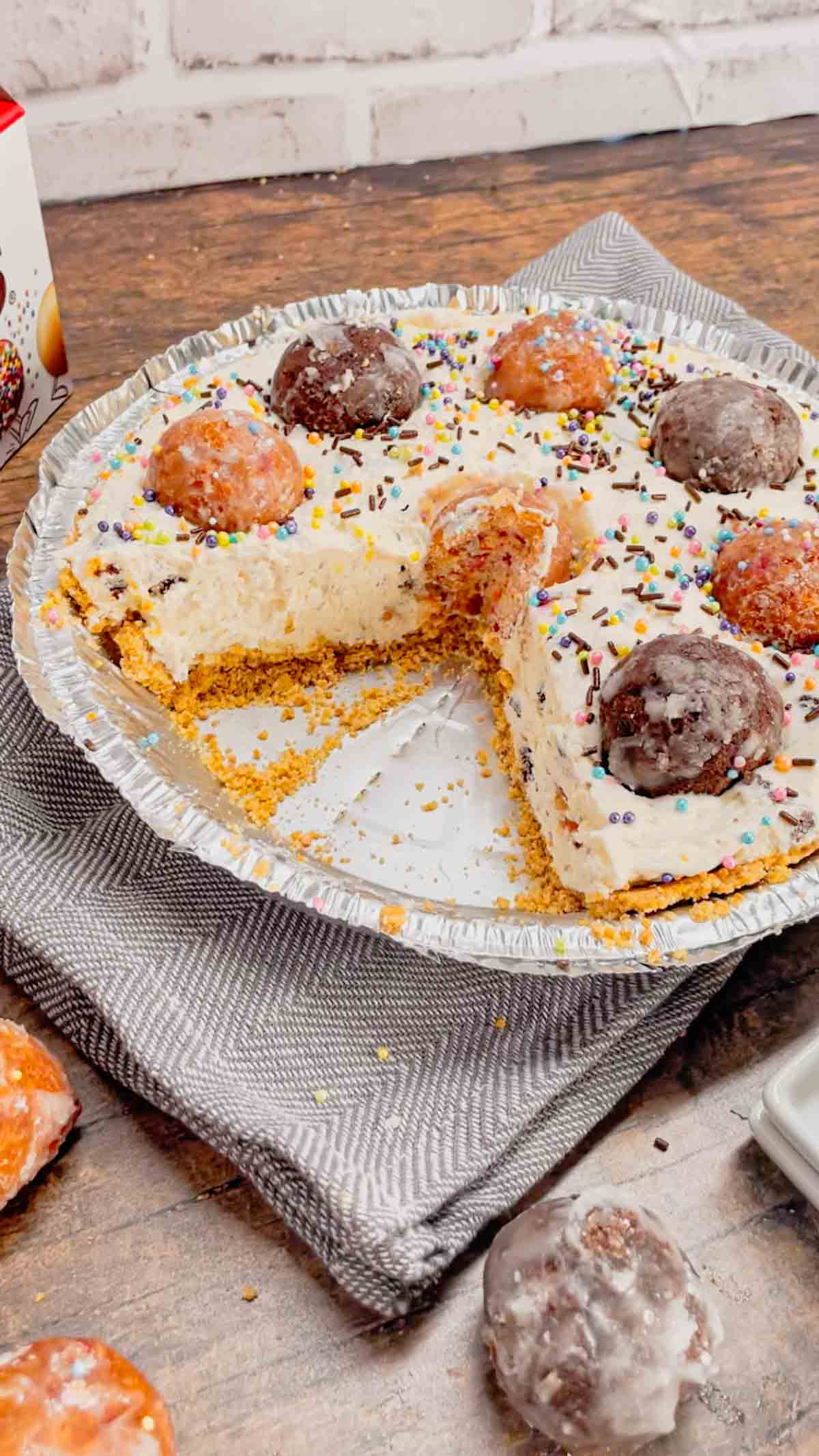 No Bake Timbit Cheesecake is a rich and creamy dessert recipe loaded with tasty donut holes. This cheesecake is made with a store bought graham pie crust and the cream cheese filling is loaded Tim Horton's chocolate and birthday cake flavoured Timbits.