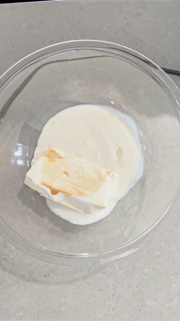 heavy cream, cream cheese, sugar and vanilla extract in a glass mixing bowl