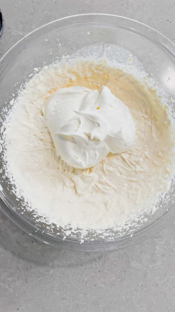 cool whip added to mixing bowl with cream cheese mixture