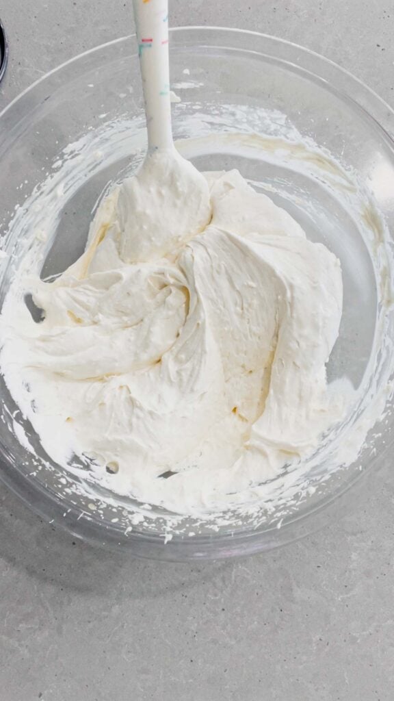 cool whip and cream cheese mixture in a glass mixing bowl
