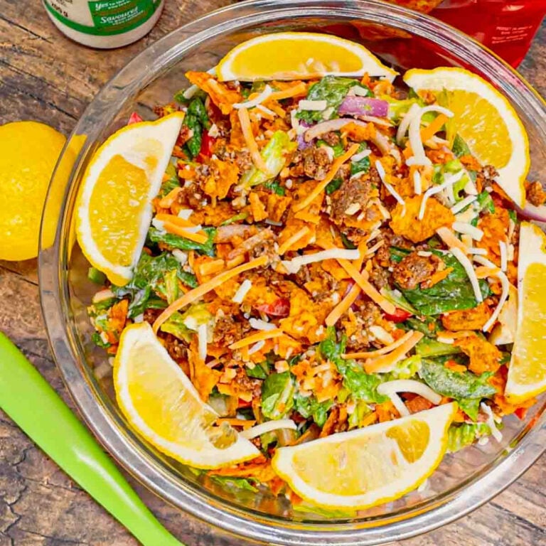 Taco Caesar Salad is a hearty and refreshing dish that can be served as a meal or as a side dish. This salad is loaded with seasoned ground beef taco meat, romaine lettuce, Caesar dressing, onions, bell peppers, parmesan cheese, nacho blend cheese, creamy Caesar dressing and crumbled Doritos nacho chips.