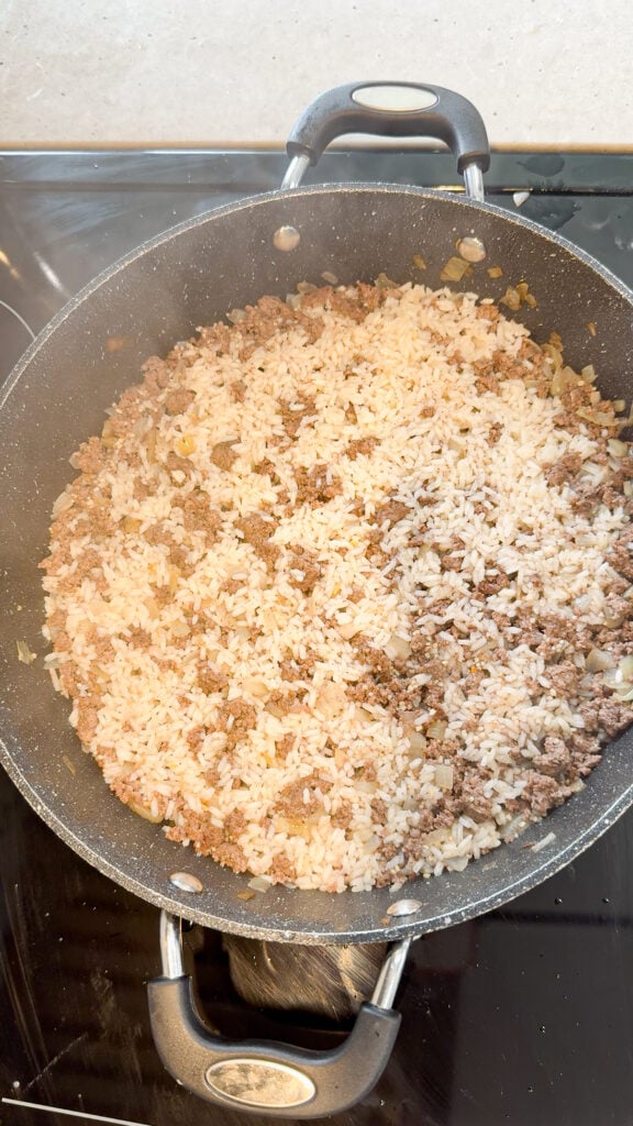 cooked ground beef and rice in a skillet