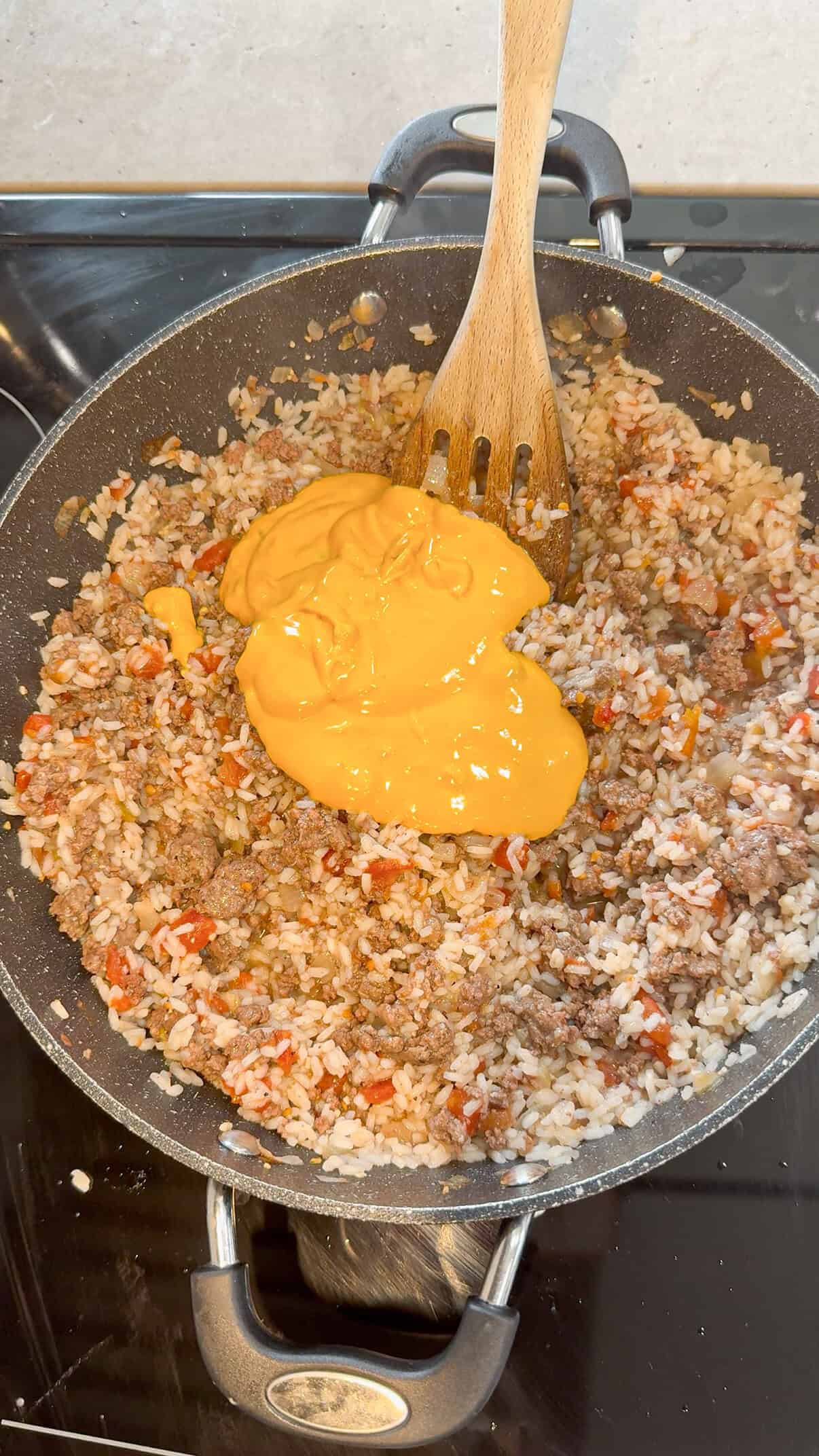 salsa con queso added to skillet with cooked ground beef and rice