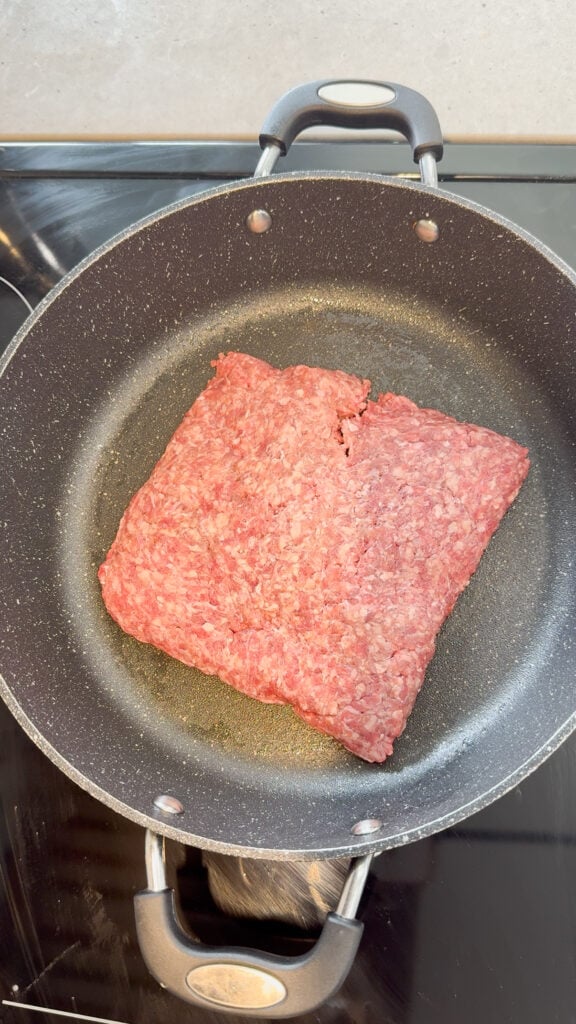 raw ground beef in a skillet