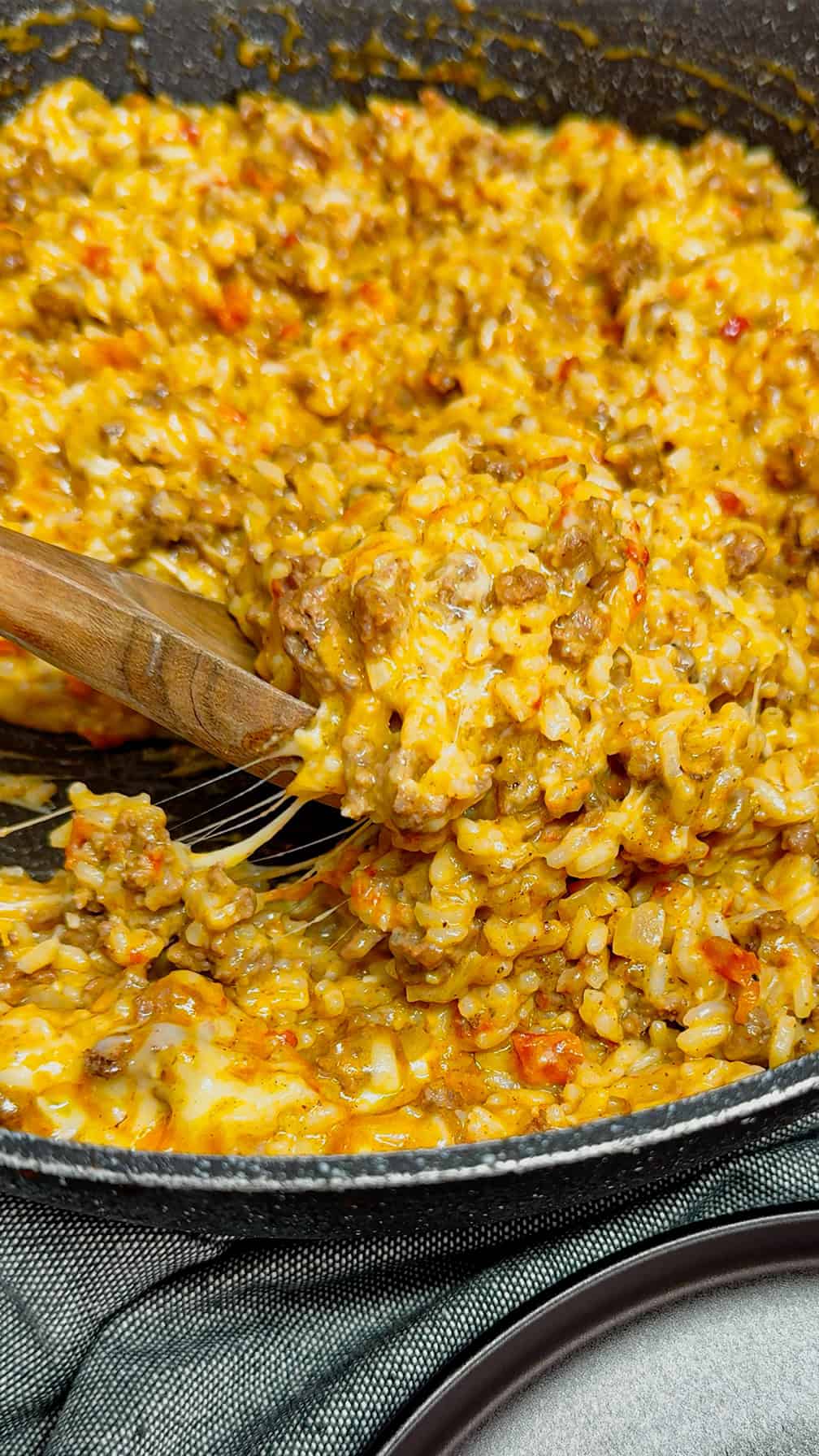 Cheesy Queso Ground Beef and Rice is an easy one pot dinner recipe perfect for busy weeknights. This hearty dish is loaded with ground beef, minute rice, Rotel diced tomatoes and green chilies, store bought salsa con queso and shredded nacho cheese.