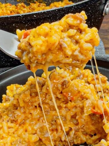 Cheesy Queso Ground Beef and Rice is an easy one pot dinner recipe perfect for busy weeknights. This hearty dish is loaded with ground beef, minute rice, Rotel diced tomatoes and green chilies, store bought salsa con queso and shredded nacho cheese.