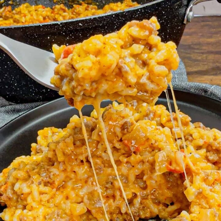 Cheesy Queso Ground Beef and Rice is an easy one pot dinner recipe perfect for busy weeknights. This hearty dish is loaded with ground beef, minute rice, Rotel diced tomatoes and green chilies, store bought salsa con queso and shredded nacho cheese.