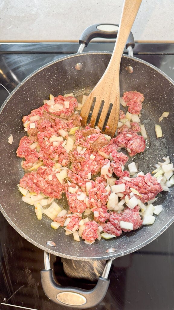 diced onions and ground beef in a skillet