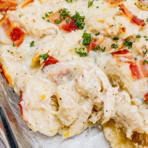 Chicken Alfredo Pierogi Casserole is an easy but hearty dinner recipe that combines two beloved classic foods into one dish. This creamy casserole is loaded with shredded rotisserie chicken, alfredo sauce, pierogies, mozzarella cheese and chopped bacon.