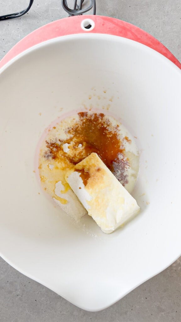 milk, vanilla extract, instant vanilla pudding mix, sugar and cream cheese in a mixing bowl