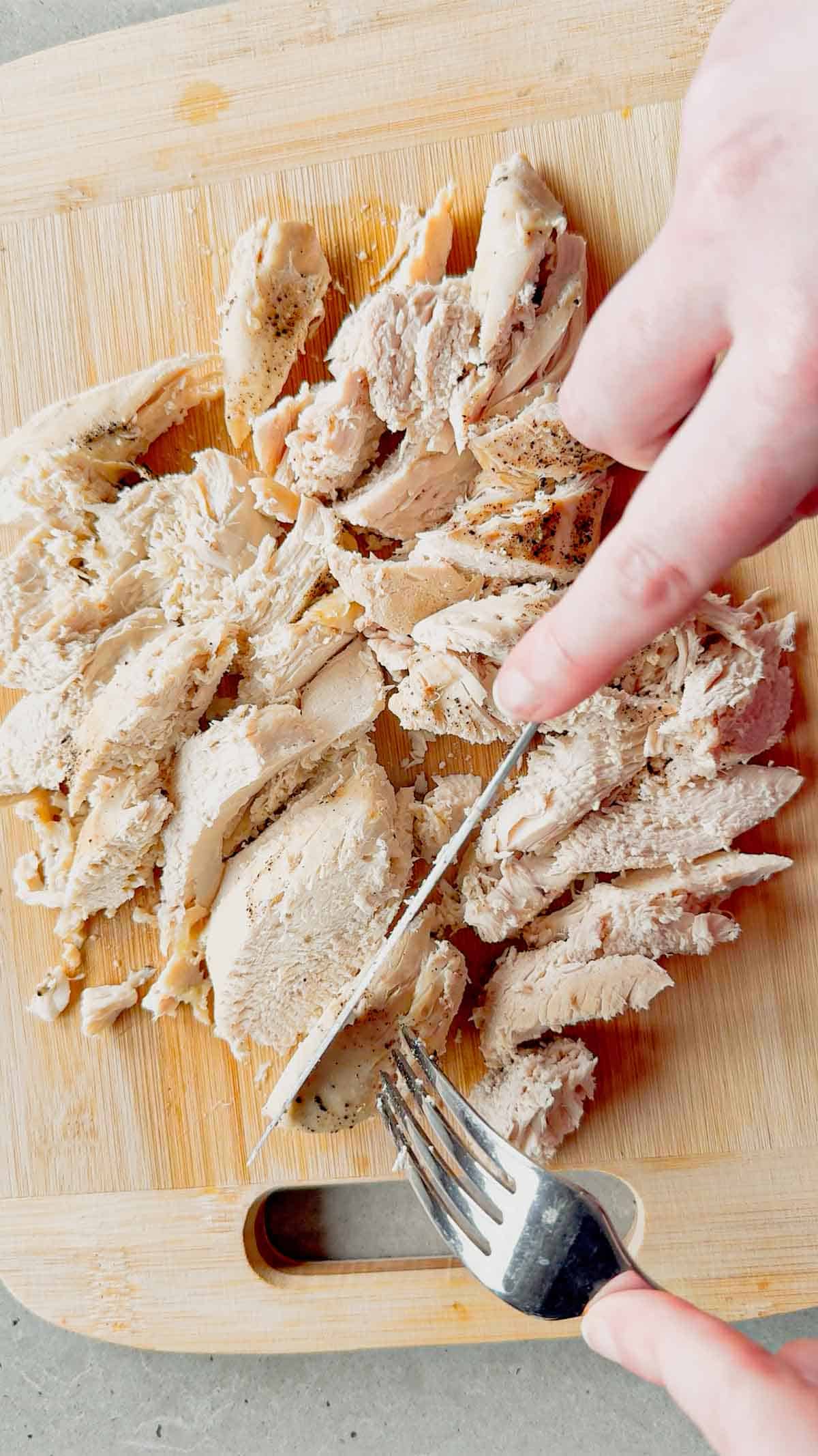 sliced chicken breasts on a cutting board