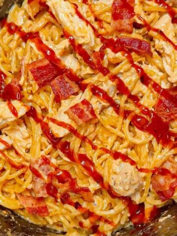 Crock Pot BBQ Alfredo Chicken Spaghetti is a flavourful pasta recipe the whole family will love. This slow cooker spaghetti recipe is loaded with chicken breast chunks and chopped bacon and is all tossed in a creamy garlic parmesan alfredo sauce with some barbecue sauce added for a fun flavour twist.