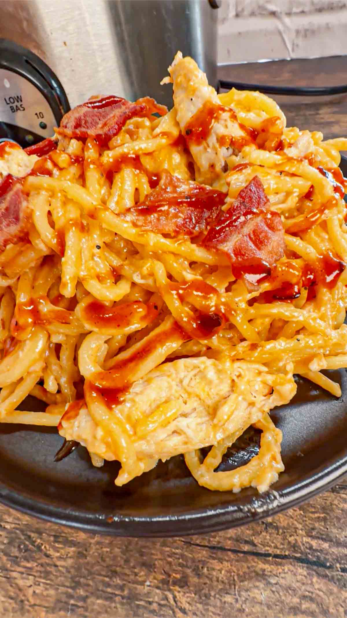 Crock Pot BBQ Alfredo Chicken Spaghetti is a flavourful pasta recipe the whole family will love. This slow cooker spaghetti recipe is loaded with chicken breast chunks and chopped bacon and is all tossed in a creamy garlic parmesan alfredo sauce with some barbecue sauce added for a fun flavour twist.