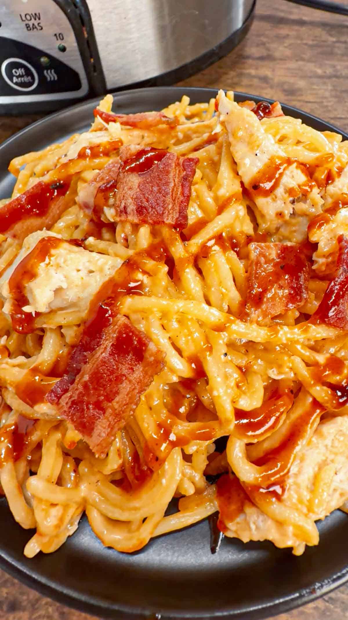 Crock Pot BBQ Alfredo Chicken Spaghetti is a flavourful pasta recipe the whole family will love. This slow cooker spaghetti recipe is loaded with chicken breast chunks and chopped bacon and is all tossed in a creamy garlic parmesan alfredo sauce with some barbecue sauce added for a fun flavour twist.