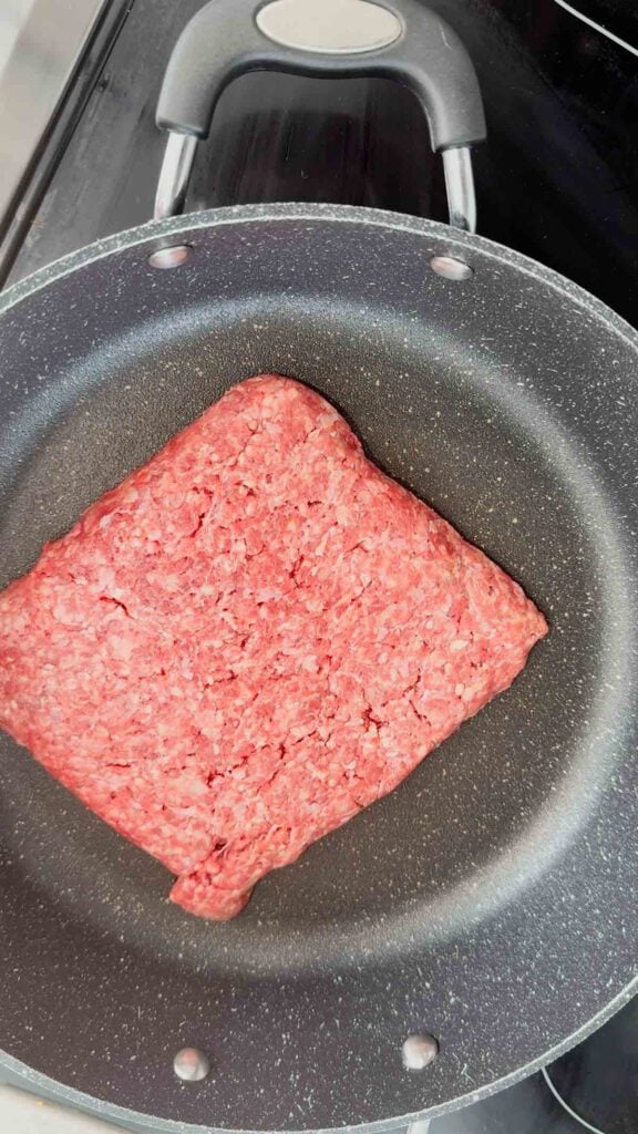 raw ground beef in a skillet
