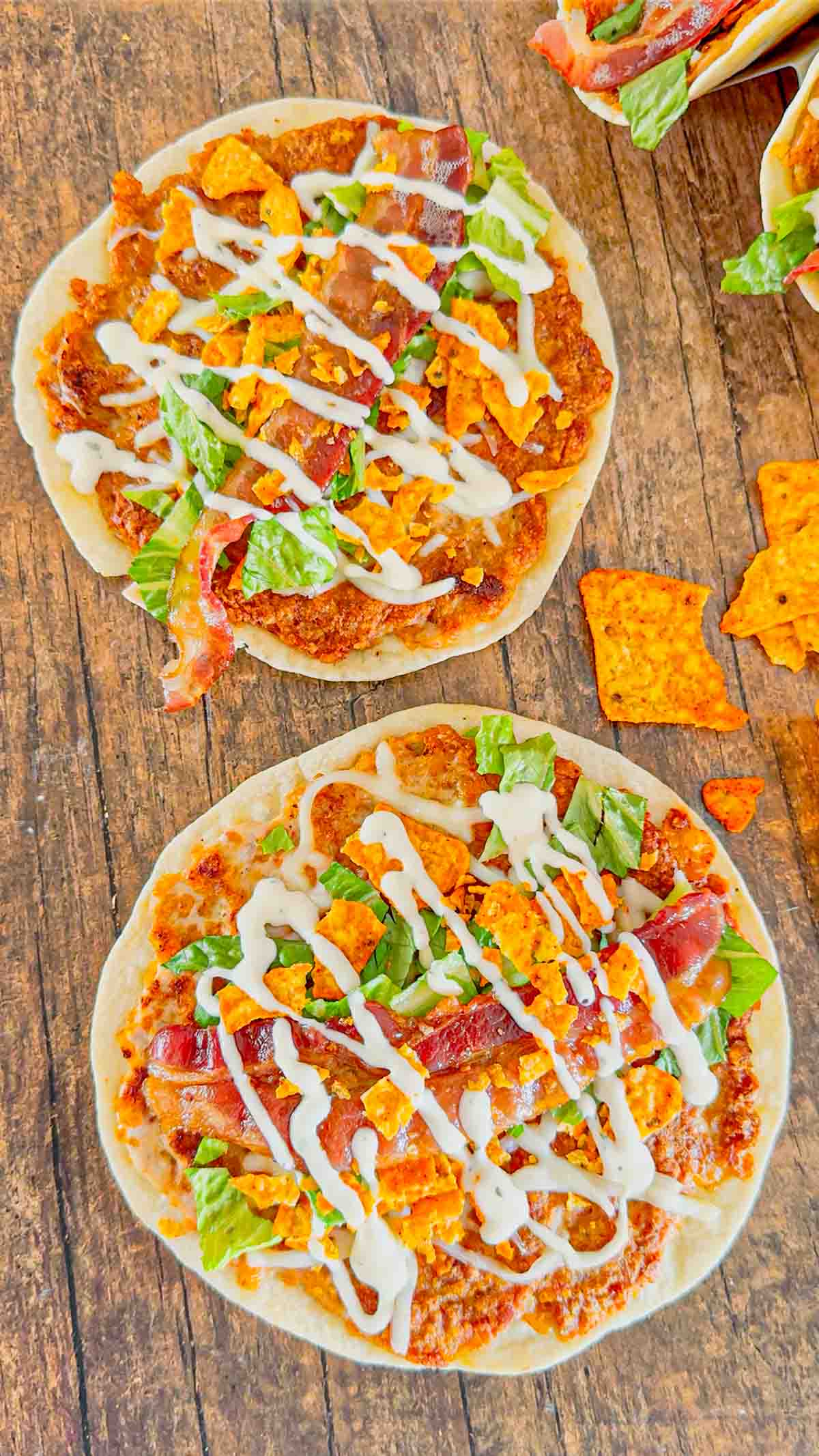 Doritos Crusted Chicken Smash Tacos are a fun twist on smash burger tacos. Flour tortillas are spread with a ground chicken and crushed Doritos mixture and fried until crispy before being topped with shredded mozzarella, chopped lettuce, crispy bacon, ranch dressing and more Doritos.
